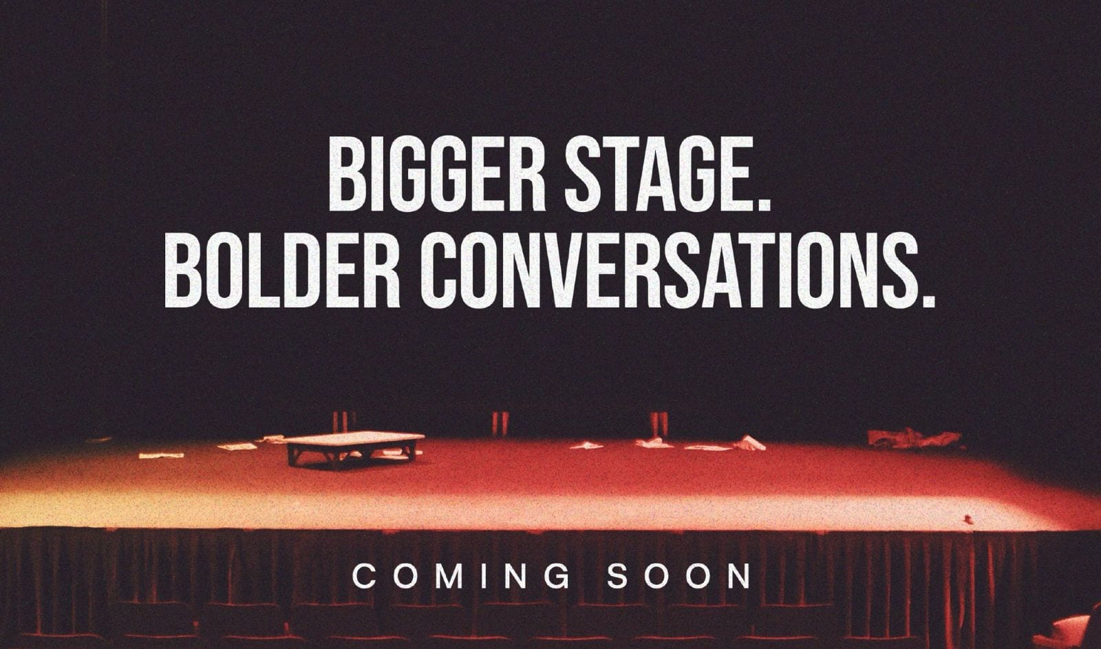 Btrust teaser image of an empty, red-lit theatre stage with the words “Bigger stage. Bolder conversations. Coming soon.”